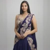 Close-up of navy blue lehenga saree blouse with heavy gold embroidery and designer drape