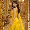 Side profile of yellow Indo western lehenga with zari cut dana work and flowing dupatta