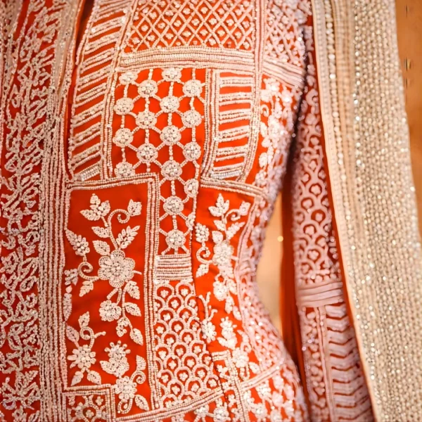 Close-up of zardosi and cut dana hand embroidery on rust sharara jacket