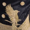 Close-up of gold zardosi and cut dana bird motif embroidery on black fabric